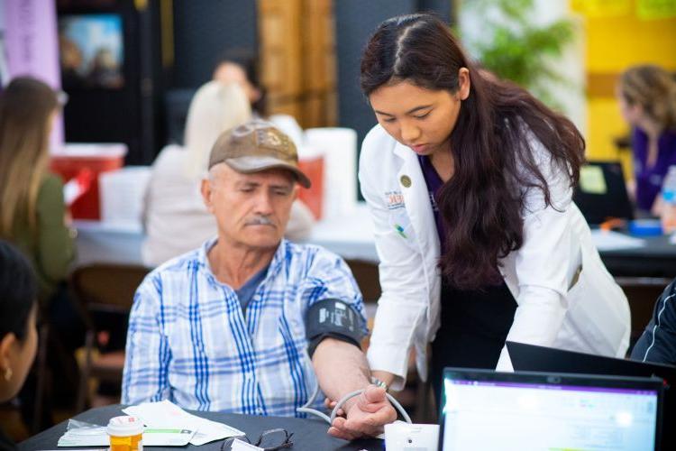 student helps patient