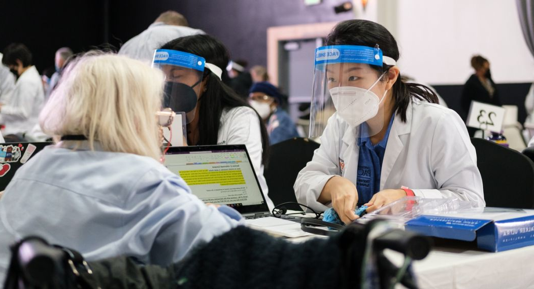 a student assists a patient at a diabetes clinic